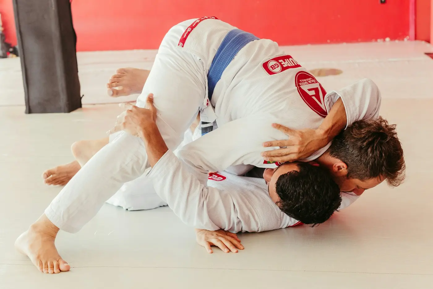 Two grapplers in gis scrambling at a competition